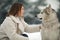 Portrait of a girl next to a dog Alaskan Malamute for a walk