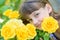 Portrait of a girl of nine years with yellow roses