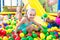 Portrait of girl playing in pool with plastic multicolored ball