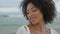 Portrait girl posing ocean on cloudy day. Playful romantic woman rest on beach