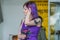 Portrait of a girl with purple hair and tattoo on the shoulder. Fashion of the Russian teenagers.