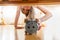 Portrait of girl reaching for alarm clock under the bed