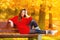 Portrait girl relaxing on bench in autumnal park.