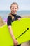 Portrait Of Girl By Sea In Wetsuit Holding Bodyboard