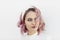 Portrait of girl with short wavy pink hair and white headband on white background