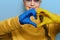 Portrait of girl showing heart shape Ukrainian yellow and blue flag on hands forming a heart. Ukraine support.
