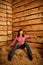 Portrait of girl sitting on pile of straw