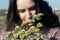 Portrait of a girl in a spring park. Inhales the aroma of a bouquet of blossoming willow. Close-up shot