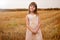 Portrait of a girl in a sundress in a field, on a sunny day. Children in nature. family weekend lifestyle