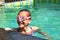 Portrait of a girl in swimming goggles. Happy girl swims in the pool