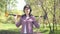 Portrait of a girl treasure hunter with a metal detector, looking at camera