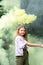 A portrait of a girl waving yellow smoke. Portrait of a girl in yellow smoke