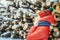 portrait of a girl in winter on a background of firewood on a cold day