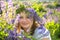 Portrait of a girl in a wreath of wild flowers