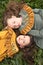 Portrait of girls in retro dresses lying on the grass one upside down with a pensive look of delight and reverence