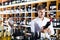 portrait of glad male customer taking bottle of wine in store