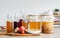 Portrait glass bottles of Kombucha healthy fermented probiotic tea drinks with ingredients red apples, strawberries, mushroom