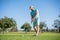 portrait of golfer in cap with golf club. people lifestyle. energetic man playing game
