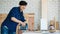 Portrait of good looking Asian carpenter working for DIY jobs in carpenter room with several kinds of woods and types of equipment