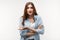 Portrait of good-looking carefree woman shrugging with spread palm, saying sorry. Studio shot, white background