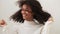 Portrait of gorgeous cheerful african american young woman with curly hair smiling