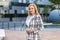 Portrait of gorgeous elegant successful businesslady standing confident determined, holding her hands together. outdoors