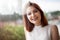 Portrait of gorgeous redhaired woman in summer rays