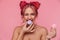 Portrait of gorgeous shirtless young woman eating macaron cookies