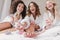 Portrait of gorgeous three women 20s wearing bathrobe sitting in