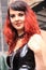 Portrait gothic woman red hair wearing vinyl dress street fashion