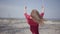 Portrait graceful elegant woman in red dress sitting on the swing and looking an amazing spectacular view of blue lake