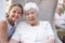 Portrait Of Granddaughter Visiting Grandmother In Retirement Home