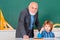 Portrait of grandfather and Son in classroom. Father and son - generation people concept. Man with old teacher learning