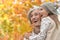 Portrait of grandmother and granddaughter in autumn park