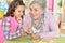 Portrait of grandmother with granddaughter counting with sticks