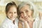 Portrait of grandmother with her cute granddaughter smiling