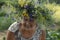 Portrait of a grandmother with a wreath on her head of grass and flowers