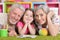 Portrait of grandparents playing with grandaughter while lying on floor