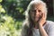 Portrait of a gray-haired adult grandmother against the background of nature