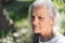 Portrait of a gray-haired adult grandmother against the background of nature