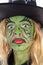 Portrait of green Halloween witch in closeup
