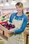 portrait greengrocer holding crate red onions