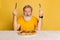 Portrait of grey bearded man getting ready to eat delicious Italian pizza isolated on yellow studio background.
