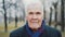 Portrait of grey-haired senior man looking at camera. 90 years old person.