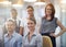 Portrait of a group of a diverse corporate group standing in an office. Happy smiling colleagues motivated and dedicated