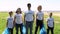 Portrait of group family recycle plastic bottle of young caucasian people volunteers in t-shirts Spbi standing in front