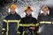 Portrait of a group of firefighters standing and walking brave and optimistic with a female as team leader.