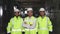 Portrait of group of professional telecommunication industry engineers smiles and looks at the camera . Workers wearing