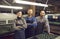 Portrait of a group of skilled happy male and female shoemakers at a shoe or garment factory.