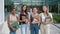 Portrait of a group of teenage student girls looking at camera smiling on a campus. Happy students at the high school